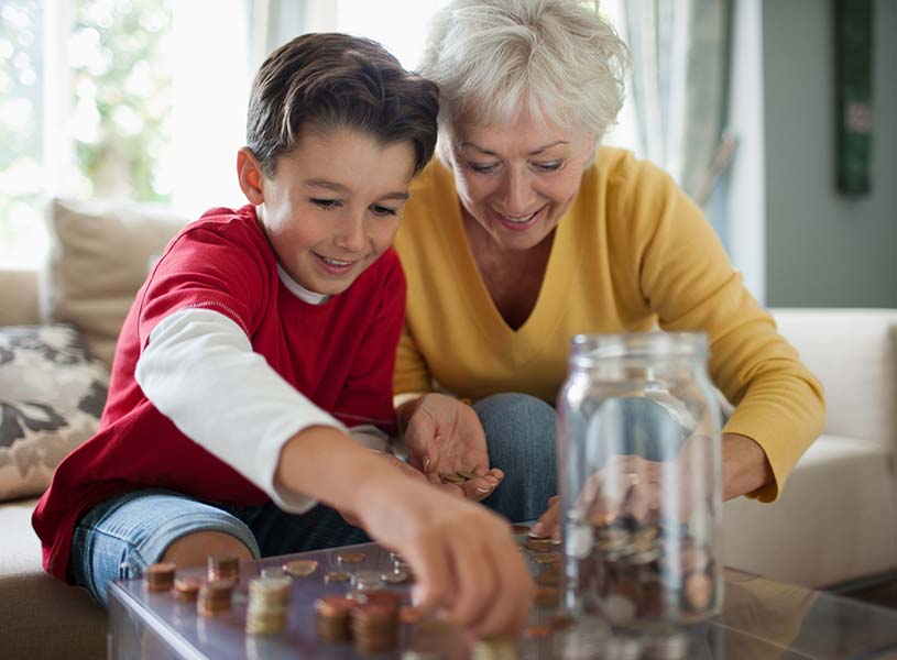 A grandmother and grandson counting coins